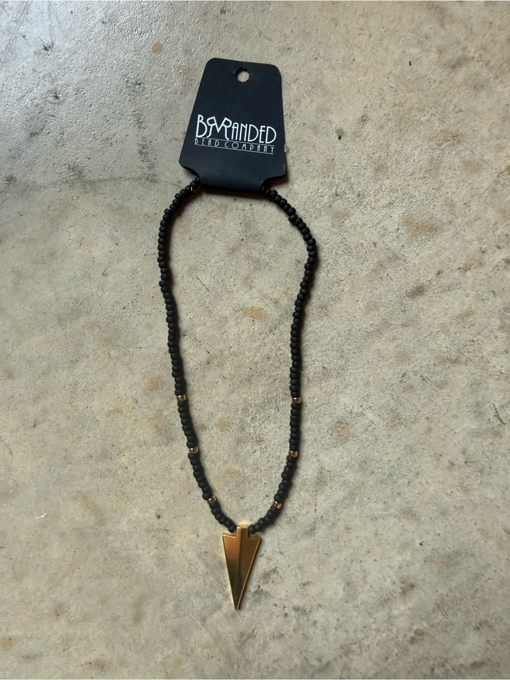 Black Beaded Necklace with Gold Arrow Pendant